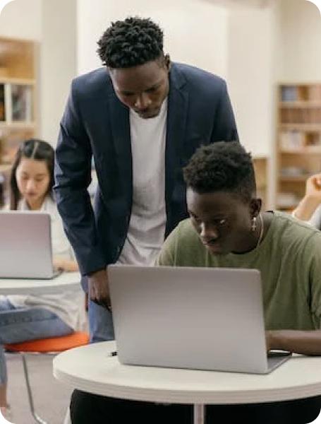 Man helping a student with a computer program
