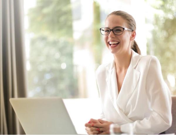 Executive woman smiling in front of a laptop