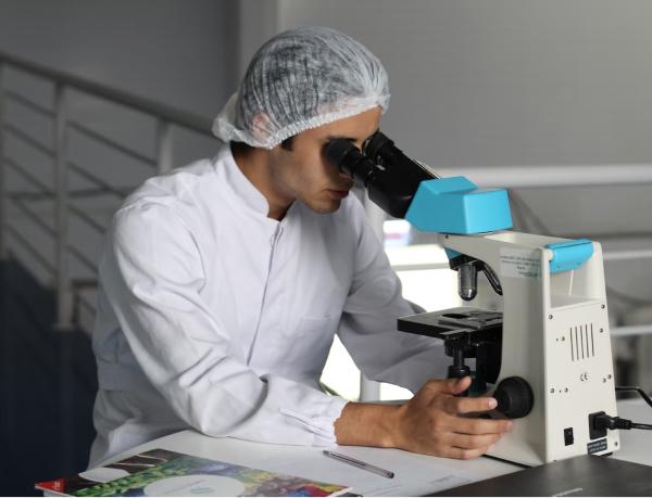 Scientist looking at microscope